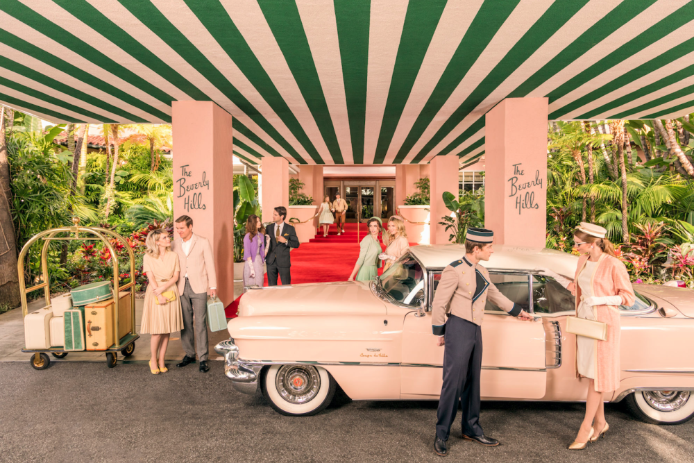 a pink car beneath a green and white striped awning at the beverly hills hotel