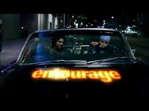 four friends in a cool car at night with the word entourage on the hood of the car