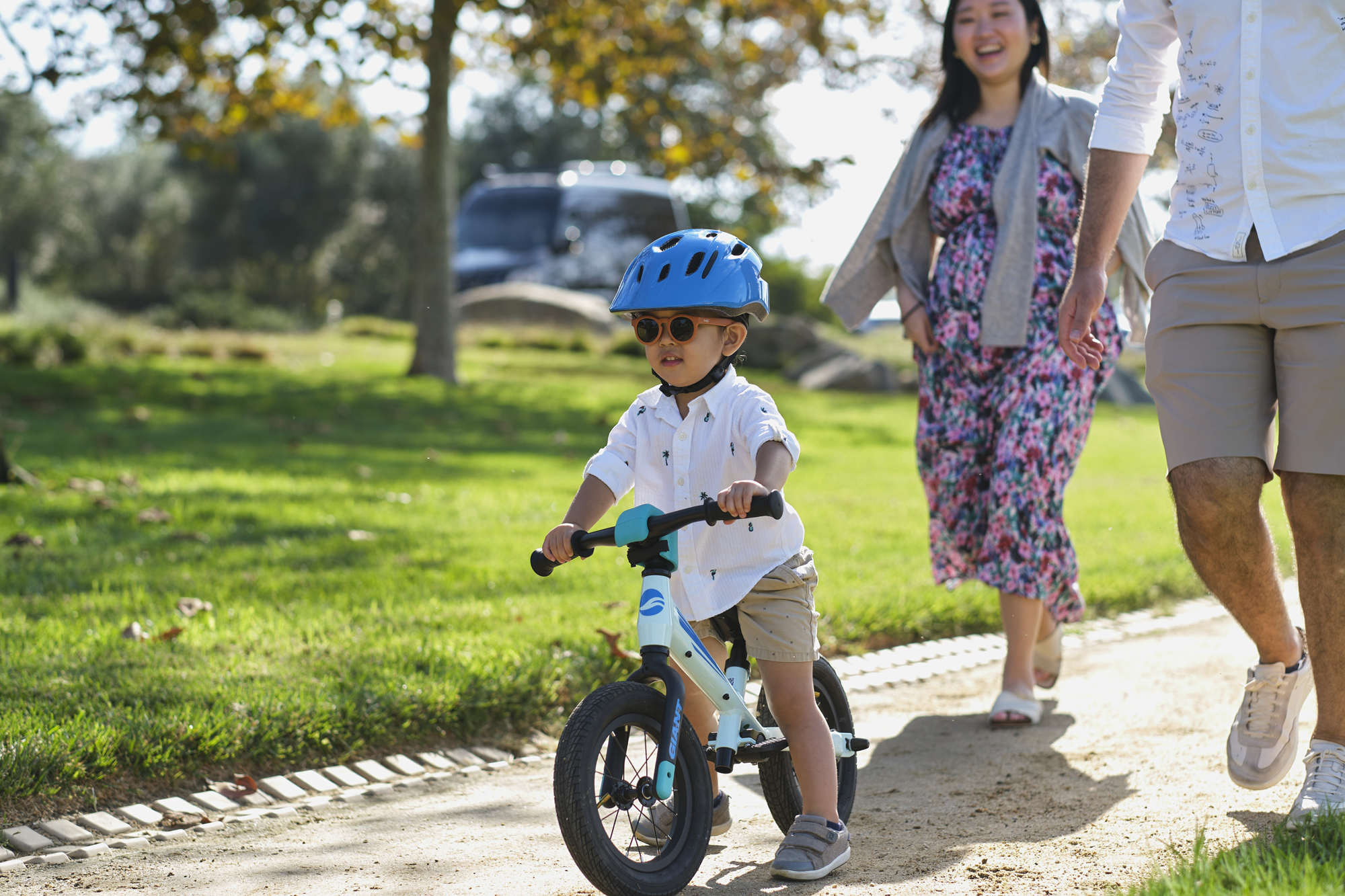 a little boy riding a kids bicycle